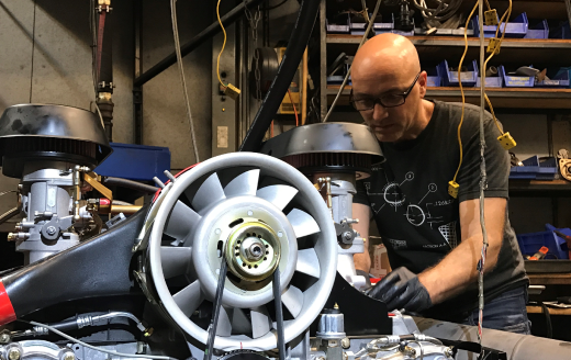 Joshua Raimond working on a large engine