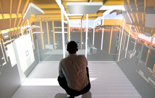 A man squatting inside a Virtual Reality Visualization cube
