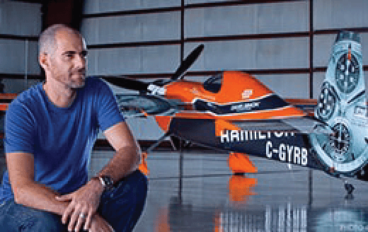 Daniel Simon sitting with one of his race car designs